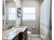 Well-lit bathroom with a granite countertop vanity and tiled floors at 1564 Cavendish Rd, Winter Park, FL 32789