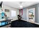 Bonus room with black carpet, a utility sink, and a back door leading to the exterior of the home at 1564 Cavendish Rd, Winter Park, FL 32789