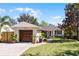 Charming one-story home with a well-manicured lawn, a driveway, and an attached garage at 1564 Cavendish Rd, Winter Park, FL 32789
