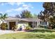 Inviting one-story home boasts lush landscaping and an attached garage at 1564 Cavendish Rd, Winter Park, FL 32789