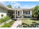 Cozy front porch with white columns and a seating area at 1564 Cavendish Rd, Winter Park, FL 32789