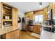 A well-appointed kitchen features stainless steel appliances and light wood cabinets at 1564 Cavendish Rd, Winter Park, FL 32789