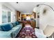 Cozy living room featuring a plush sofa, decorative rug, and modern light fixture at 1564 Cavendish Rd, Winter Park, FL 32789