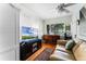Bright living room with a large window, sleek TV, and cozy seating area at 1564 Cavendish Rd, Winter Park, FL 32789