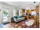 Bright living room with a large window and open access to the kitchen area, perfect for entertaining at 1564 Cavendish Rd, Winter Park, FL 32789