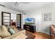 Comfortable living room with a TV, hardwood floors, and decorative accents at 1564 Cavendish Rd, Winter Park, FL 32789