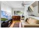 Comfortable living room with a large window, modern TV, and stylish furniture at 1564 Cavendish Rd, Winter Park, FL 32789