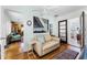 Cozy sitting area with a comfortable couch, hardwood floors, and stylish decor at 1564 Cavendish Rd, Winter Park, FL 32789