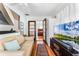Comfortable seating area with access to multiple rooms, hardwood floors, and a TV at 1564 Cavendish Rd, Winter Park, FL 32789