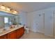 Bathroom with double vanity, garden tub, tiled floor, and a separate glass enclosed shower at 1750 Morning Sky Dr, Winter Garden, FL 34787