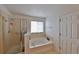 Bathroom featuring a soaking tub with tile surround and a glass enclosed shower stall at 1750 Morning Sky Dr, Winter Garden, FL 34787