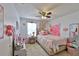 Bright bedroom with a ceiling fan, a window, and stylish decor at 1750 Morning Sky Dr, Winter Garden, FL 34787