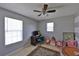 Bedroom with ceiling fan, two windows, and desk at 1750 Morning Sky Dr, Winter Garden, FL 34787