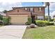 Charming two-story home featuring a well-manicured lawn, beautiful landscaping and attached two-car garage at 1750 Morning Sky Dr, Winter Garden, FL 34787