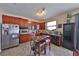 Well-equipped kitchen with wooden cabinets, stainless steel appliances, breakfast bar and neutral color scheme at 1750 Morning Sky Dr, Winter Garden, FL 34787