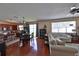 Spacious living room showcasing hardwood floors, neutral walls, bright windows and seamless access to kitchen at 1750 Morning Sky Dr, Winter Garden, FL 34787