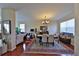 Bright open concept living and dining room with shiny wood floors, neutral walls and contemporary lighting fixture at 1750 Morning Sky Dr, Winter Garden, FL 34787