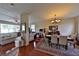 Bright open concept living and dining room with shiny wood floors, neutral walls and contemporary lighting fixture at 1750 Morning Sky Dr, Winter Garden, FL 34787