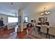 Bright open concept living and dining room with shiny wood floors, neutral walls and contemporary lighting fixture at 1750 Morning Sky Dr, Winter Garden, FL 34787