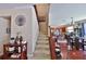 Staircase leading to the upper level with views into the kitchen and dining area featuring hardwood floors at 1750 Morning Sky Dr, Winter Garden, FL 34787
