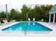 Community pool with lounge chairs and lush greenery at 1750 Morning Sky Dr, Winter Garden, FL 34787