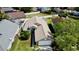 Aerial view of a tan single Gathering home featuring a well-maintained lawn and surrounded by neighboring houses at 193 Lansbrook Ct, Ocoee, FL 34761
