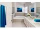 Relaxing bathroom featuring a soaking tub, marble countertop vanity, and neutral tile accents at 193 Lansbrook Ct, Ocoee, FL 34761