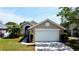 Charming single-story home with a well-manicured lawn and a two-car garage at 193 Lansbrook Ct, Ocoee, FL 34761