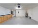 Spacious garage with epoxy floors, storage cabinets, and overhead lighting at 193 Lansbrook Ct, Ocoee, FL 34761