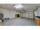 Spacious garage with epoxy floors, storage cabinets, and overhead lighting at 193 Lansbrook Ct, Ocoee, FL 34761
