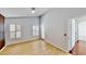 Clean and bright main bedroom with neutral walls, wood flooring, and access to an ensuite bathroom at 193 Lansbrook Ct, Ocoee, FL 34761