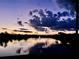 Scenic pond view with twilight sky and water fountain at 193 Lansbrook Ct, Ocoee, FL 34761