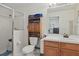 The bathroom features a glass-enclosed shower, wood cabinets, and ample storage at 20705 Nettleton St, Orlando, FL 32833
