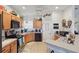 Functional kitchen with wood cabinets, black appliances, and ample countertop space for meal preparation at 20705 Nettleton St, Orlando, FL 32833