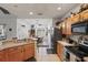 Efficient kitchen with wood cabinetry and a breakfast bar, seamlessly connecting to the dining area at 20705 Nettleton St, Orlando, FL 32833