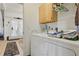 Functional laundry room with a washing machine, dryer, and storage cabinet at 20705 Nettleton St, Orlando, FL 32833