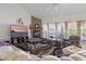 Cozy living room with a brick fireplace, neutral-toned furniture, and ample natural light at 20705 Nettleton St, Orlando, FL 32833