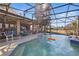 A screened-in pool with an outdoor kitchen and ample seating area at 20705 Nettleton St, Orlando, FL 32833