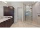 Spacious bathroom featuring a marble vanity with dark wood cabinets and a glass-enclosed shower at 225 Magnolia St, Windermere, FL 34786