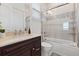 Bathroom vanity with dark cabinets and marble countertops, paired with a shower-tub combination at 225 Magnolia St, Windermere, FL 34786
