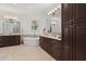 Beautiful bathroom with double vanities, custom cabinetry, soaking tub, and decorative tile accent wall at 225 Magnolia St, Windermere, FL 34786