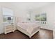 Comfortable bedroom with hardwood floors and large windows overlooking a lush landscape at 225 Magnolia St, Windermere, FL 34786