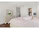 Cozy bedroom features hardwood floors, dresser, and ensuite bathroom at 225 Magnolia St, Windermere, FL 34786