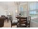 Bright dining area with floor-to-ceiling windows and views of the pool and waterfront at 225 Magnolia St, Windermere, FL 34786