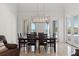 Elegant dining room with modern lighting, seating for six, and access to outdoor spaces at 225 Magnolia St, Windermere, FL 34786