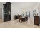 Spacious dining room featuring a grand chandelier and a modern elevator at 225 Magnolia St, Windermere, FL 34786