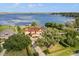 Stunning Mediterranean-style home with a terracotta roof and sprawling lawn overlooking the lake at 225 Magnolia St, Windermere, FL 34786