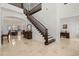 Bright foyer featuring marble floors, a staircase with wood trim, high ceilings, and plenty of natural light at 225 Magnolia St, Windermere, FL 34786