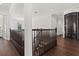 Upstairs hallway with hardwood floors, custom banisters, and a modern glass elevator at 225 Magnolia St, Windermere, FL 34786
