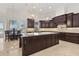 Gourmet kitchen with custom cabinets, island, and stainless steel appliances at 225 Magnolia St, Windermere, FL 34786